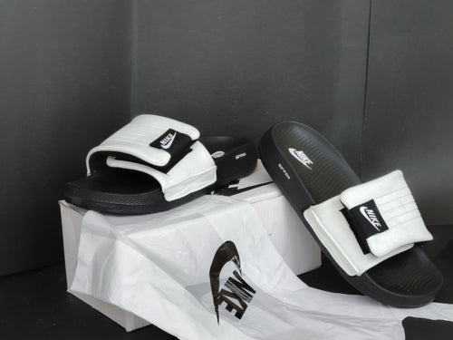 Black and white slides with Nike logo on a black background